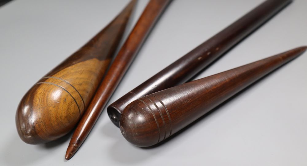 Three 19th century lignum vitae fids and a similar rule, longest 45.5cm